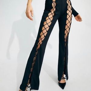 Black leggings, bell bottoms, fishnet openings on both thighs